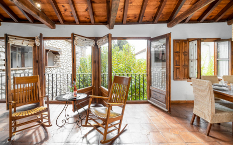 This living / dining area overlooks patio / gardens